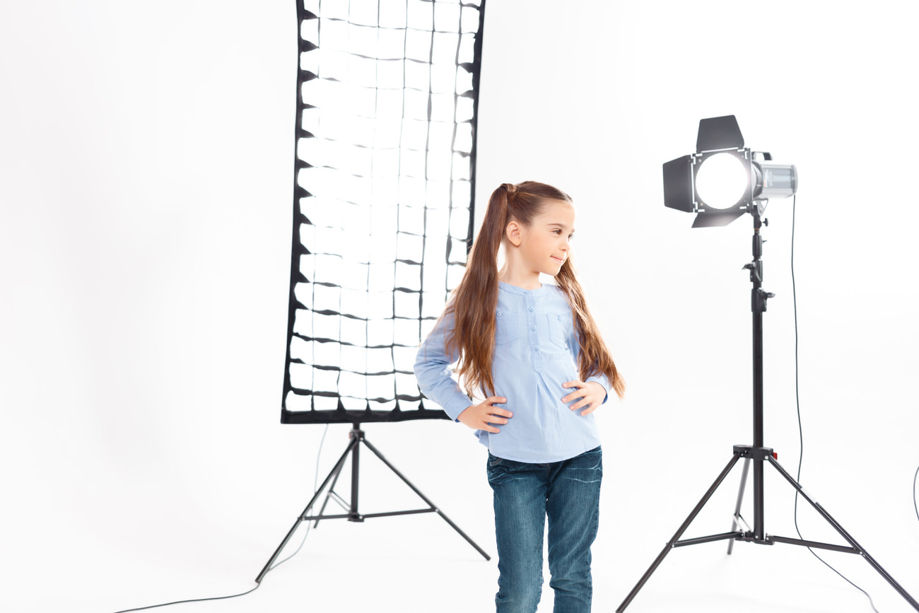 Little model poses heartily during working process.